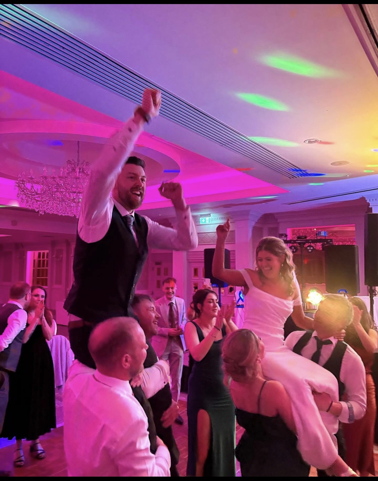 Newlyweds celebrating with their wedding guests on the dance floor